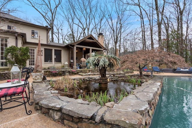 exterior space featuring a pool and a patio