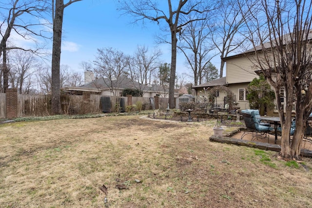 view of yard with fence and a patio