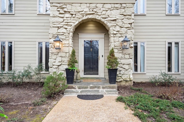 view of exterior entry featuring stone siding