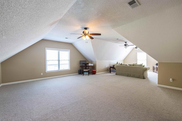 unfurnished bedroom featuring visible vents, baseboards, ceiling fan, vaulted ceiling, and carpet floors