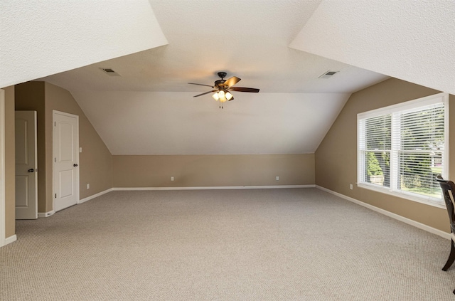 bonus room featuring baseboards, visible vents, and light colored carpet