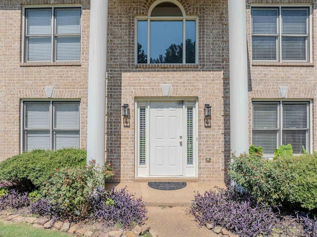 property entrance featuring brick siding