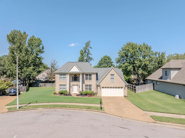 view of front of home with concrete driveway, a front lawn, fence, and brick siding