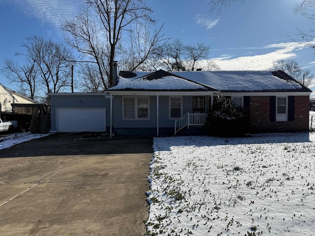 single story home with a garage, concrete driveway, and brick siding