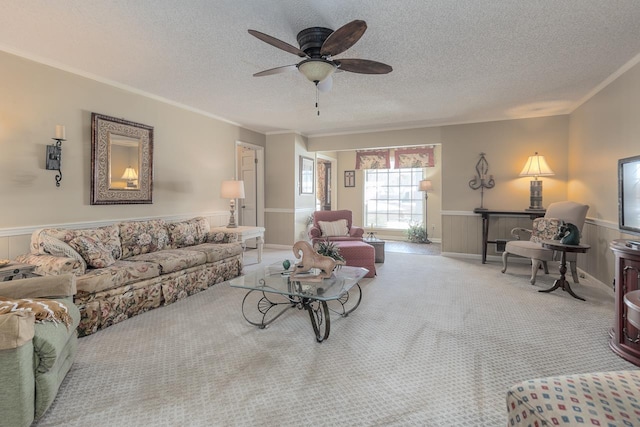 living room featuring ornamental molding, light colored carpet, and wainscoting