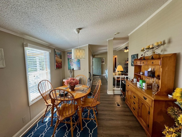 dining room featuring visible vents, dark wood finished floors, a ceiling fan, ornamental molding, and a textured ceiling