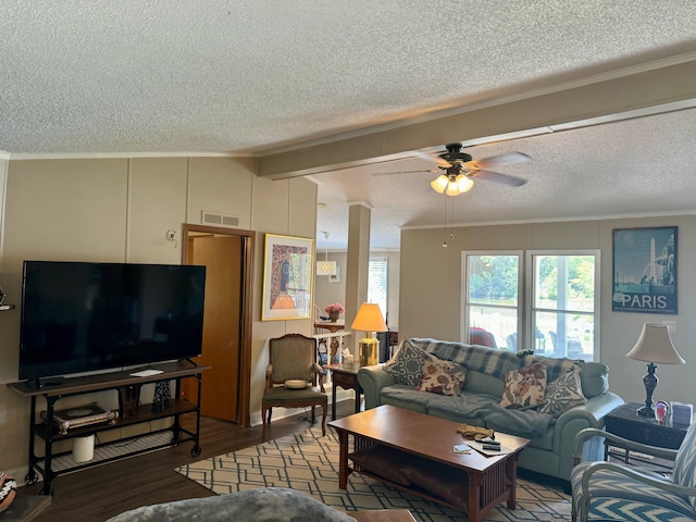 living area featuring visible vents, ceiling fan, wood finished floors, a textured ceiling, and crown molding