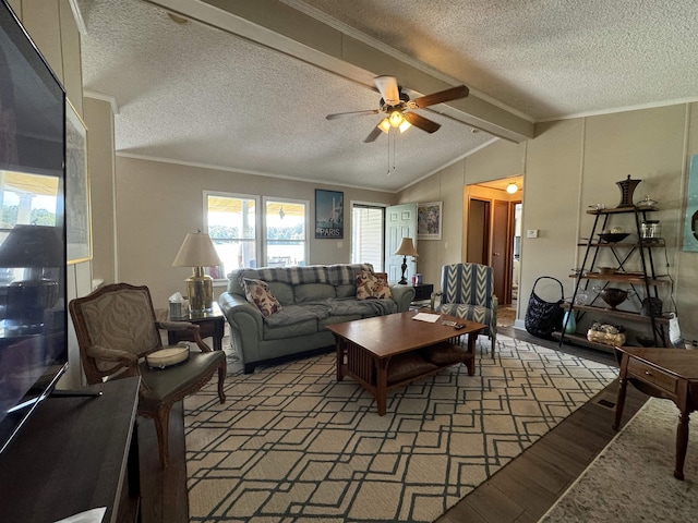 living room with vaulted ceiling with beams, light wood finished floors, ornamental molding, ceiling fan, and a textured ceiling