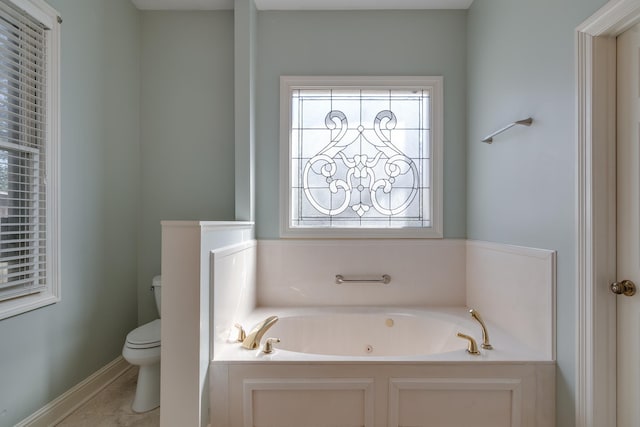 full bathroom with a garden tub, toilet, and tile patterned floors