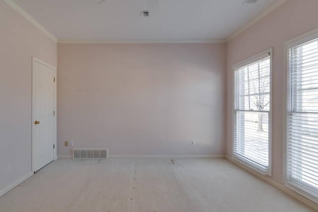 empty room featuring ornamental molding, visible vents, light carpet, and baseboards