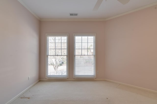 unfurnished room with light colored carpet, a wealth of natural light, and visible vents