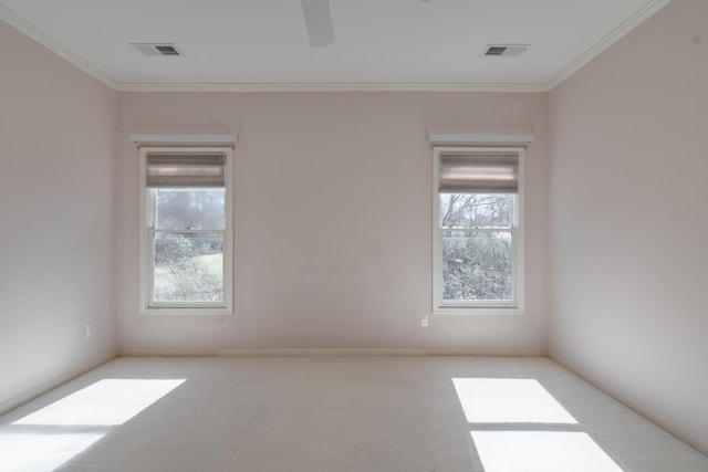 empty room with ornamental molding, visible vents, and ceiling fan