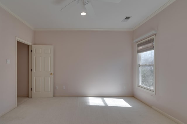 spare room featuring ornamental molding, visible vents, light carpet, and baseboards