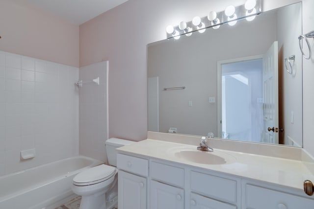 bathroom featuring toilet, shower / washtub combination, and vanity