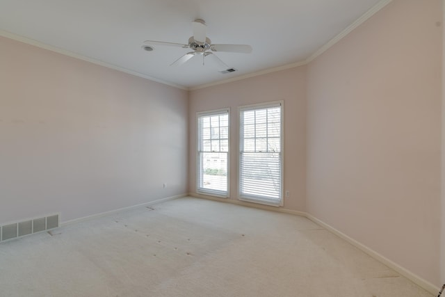 spare room featuring ornamental molding, visible vents, and baseboards