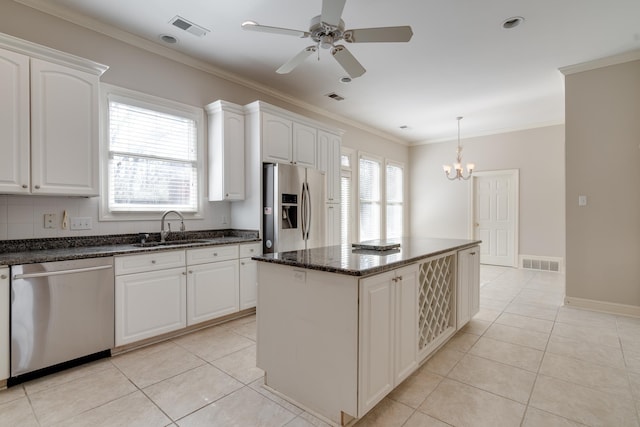 kitchen with visible vents, white cabinets, dark stone counters, appliances with stainless steel finishes, and a sink