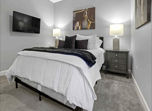 bedroom with carpet flooring and baseboards