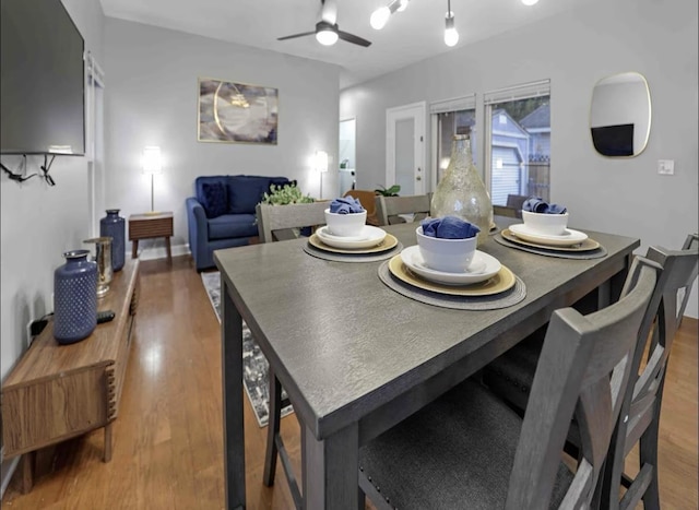 dining space with wood finished floors and a ceiling fan