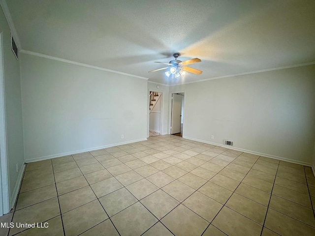 empty room with a ceiling fan, visible vents, crown molding, and a textured ceiling