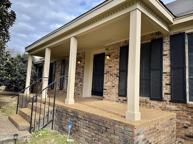 doorway to property with brick siding