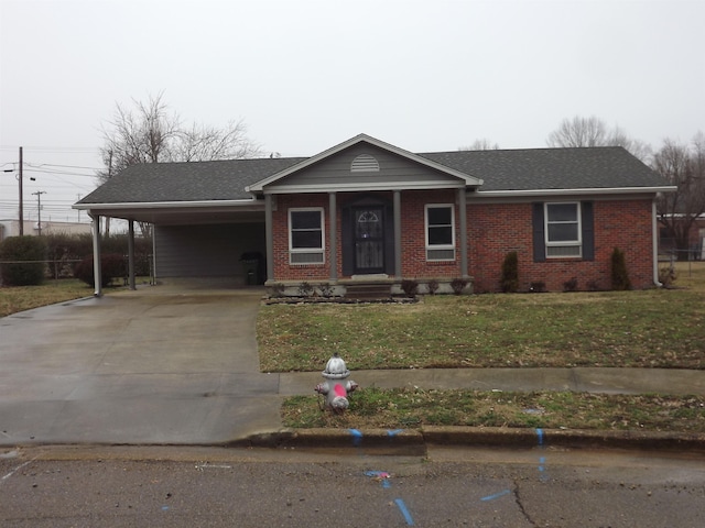 single story home with brick siding, a shingled roof, driveway, a carport, and a front yard