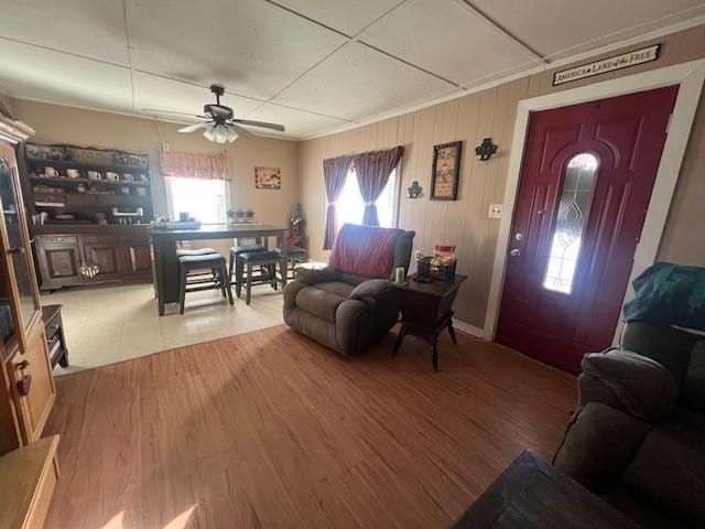 living room with light wood finished floors and a ceiling fan