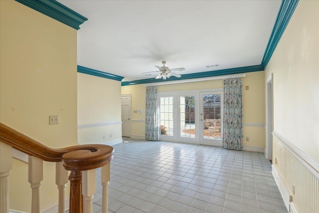 962 E Riverwalk Dr E, Memphis, TN 38120 - empty room featuring a wainscoted wall, ornamental molding, light tile patterned flooring, and a ceiling fan