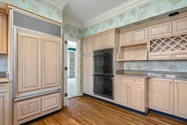 962 E Riverwalk Dr E, Memphis, TN 38120 - kitchen with light stone counters, dobule oven black, wood finished floors, ornamental molding, and wallpapered walls