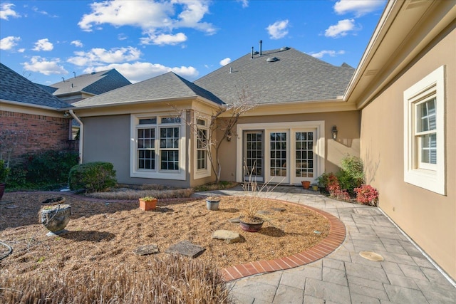 962 E Riverwalk Dr E, Memphis, TN 38120 - rear view of house featuring a patio area, a shingled roof, and stucco siding