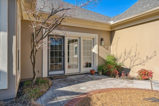 962 E Riverwalk Dr E, Memphis, TN 38120 - doorway to property with a patio area, stucco siding, and roof with shingles