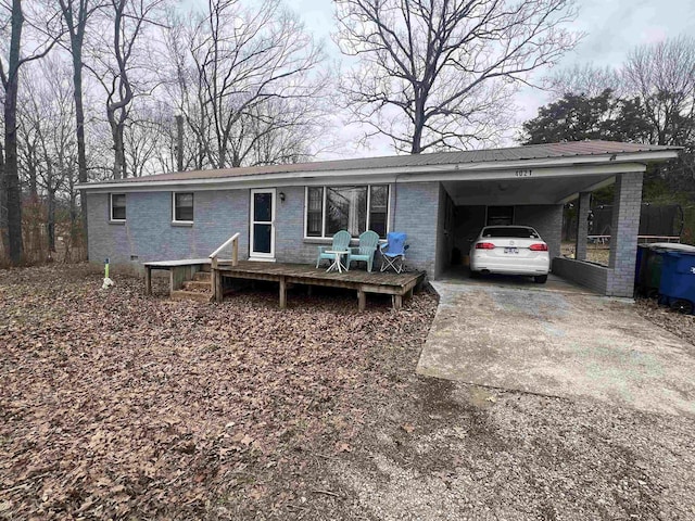 ranch-style house with concrete driveway, brick siding, and an attached carport