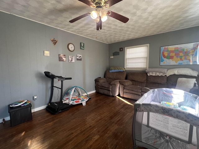 living room featuring dark wood finished floors, a textured ceiling, baseboards, and ceiling fan