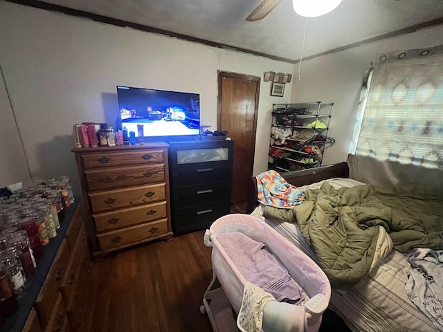 bedroom featuring crown molding, ceiling fan, and dark wood-style flooring