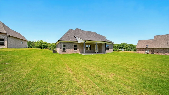 1405 Armstrong Rd, Drummonds, TN 38023 - back of property featuring a yard, cooling unit, a patio area, and brick siding