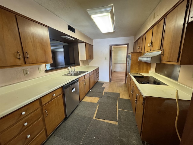 kitchen featuring visible vents, brown cabinets, stainless steel appliances, under cabinet range hood, and a sink