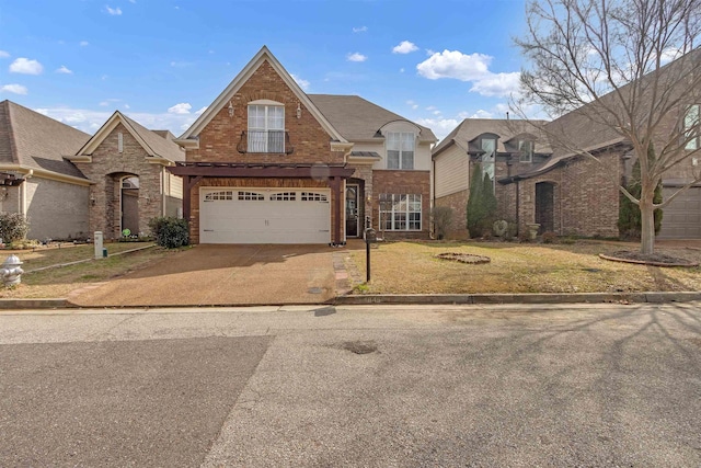 view of front of property featuring a garage, driveway, brick siding, and a front lawn