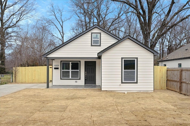 bungalow-style home with fence