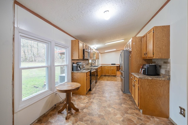 kitchen with brown cabinetry, tasteful backsplash, ornamental molding, and stainless steel appliances
