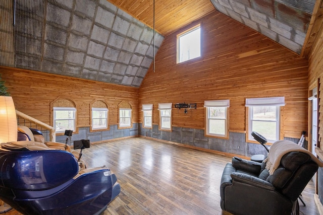 living room featuring high vaulted ceiling, wood ceiling, wood walls, and wood finished floors