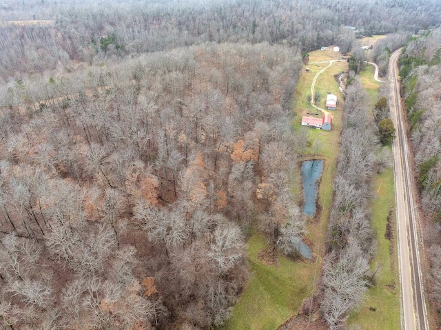 birds eye view of property featuring a view of trees