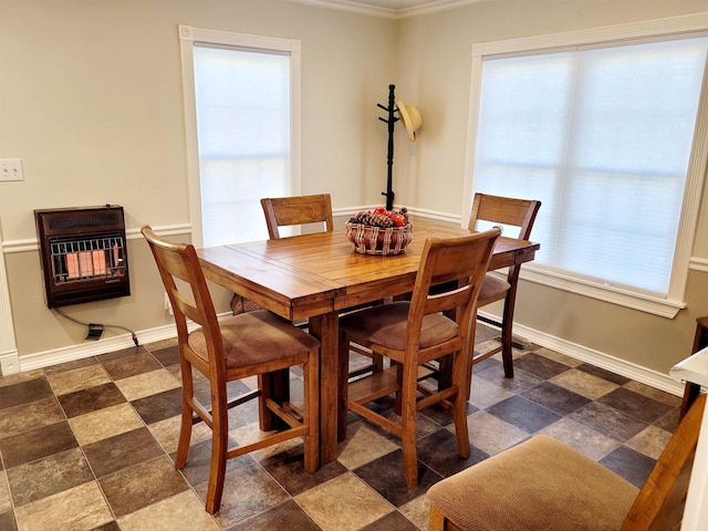 dining room with heating unit, plenty of natural light, and baseboards