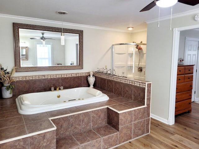 bathroom featuring a tub with jets, a stall shower, wood finished floors, and crown molding