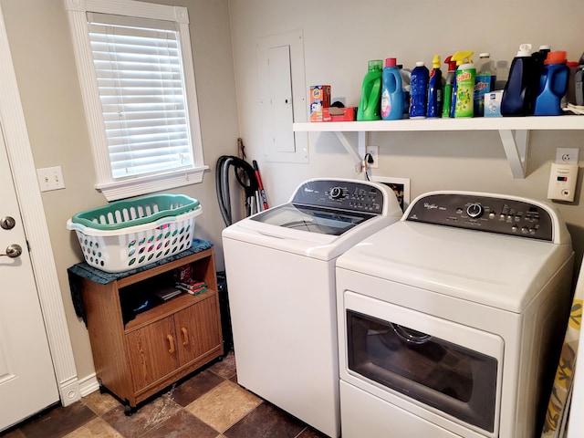 clothes washing area with laundry area, stone finish floor, independent washer and dryer, and electric panel