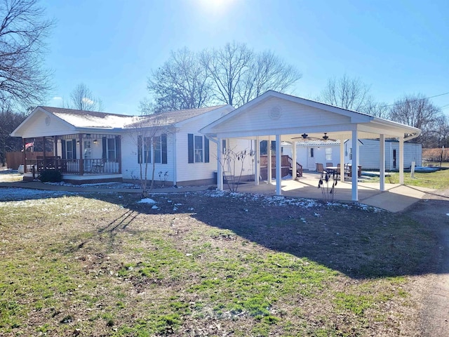 exterior space featuring covered porch, a ceiling fan, and a patio