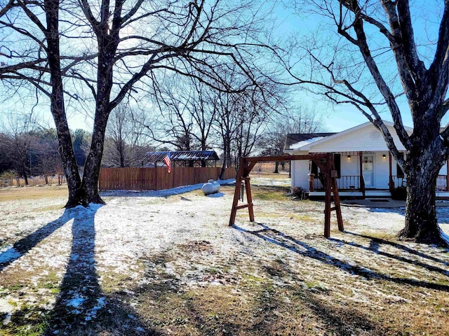 view of yard with a porch and fence