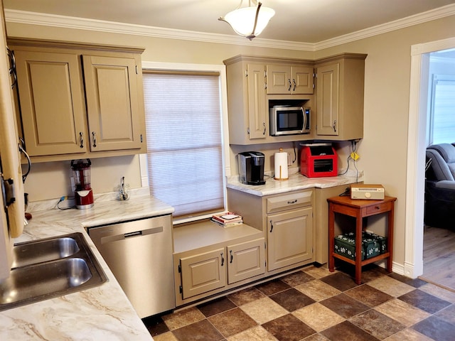 kitchen with stainless steel appliances, crown molding, and a sink