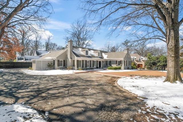 view of front of property with fence and a chimney