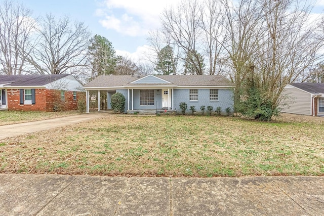 ranch-style house featuring driveway, a carport, a front lawn, and brick siding