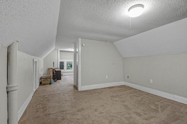 1151 Central Ave, Memphis, TN 38104 - additional living space with lofted ceiling, light carpet, a textured ceiling, and baseboards