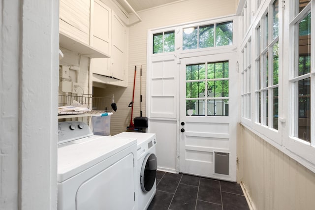 1151 Central Ave, Memphis, TN 38104 - washroom with dark tile patterned floors, washing machine and clothes dryer, cabinet space, and wooden walls